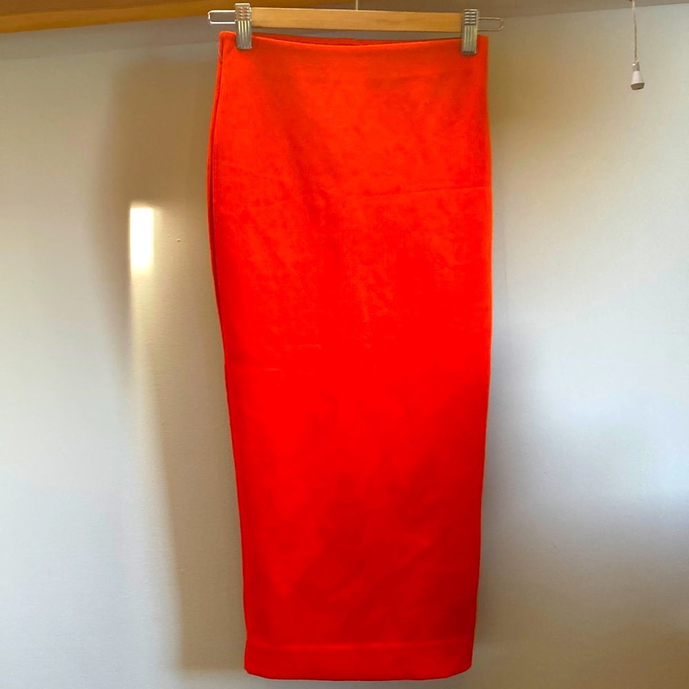 Bright red/orange tight skirt. Very hot 🔥